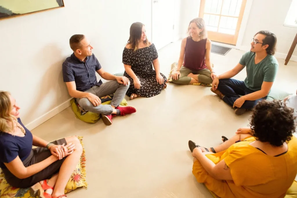 A group session with folks sitting on the floor