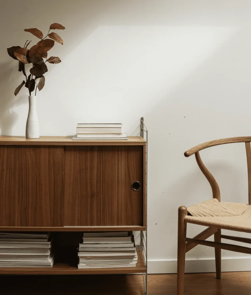 a chair with a side table and a plant